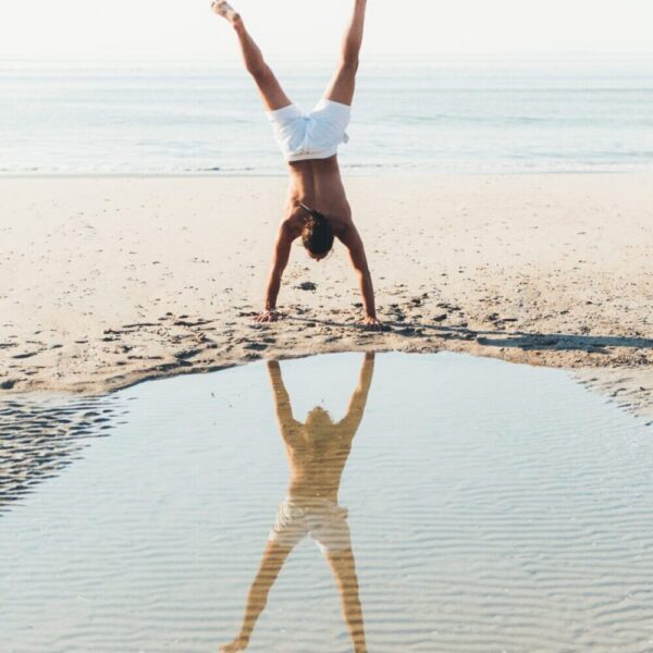 hand stand on the beach